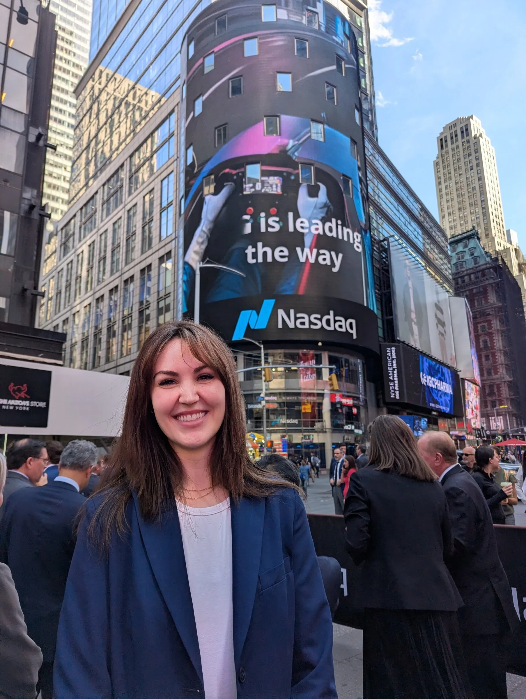 Eryn Peters in Times Square in front of the Nasdaq billboard