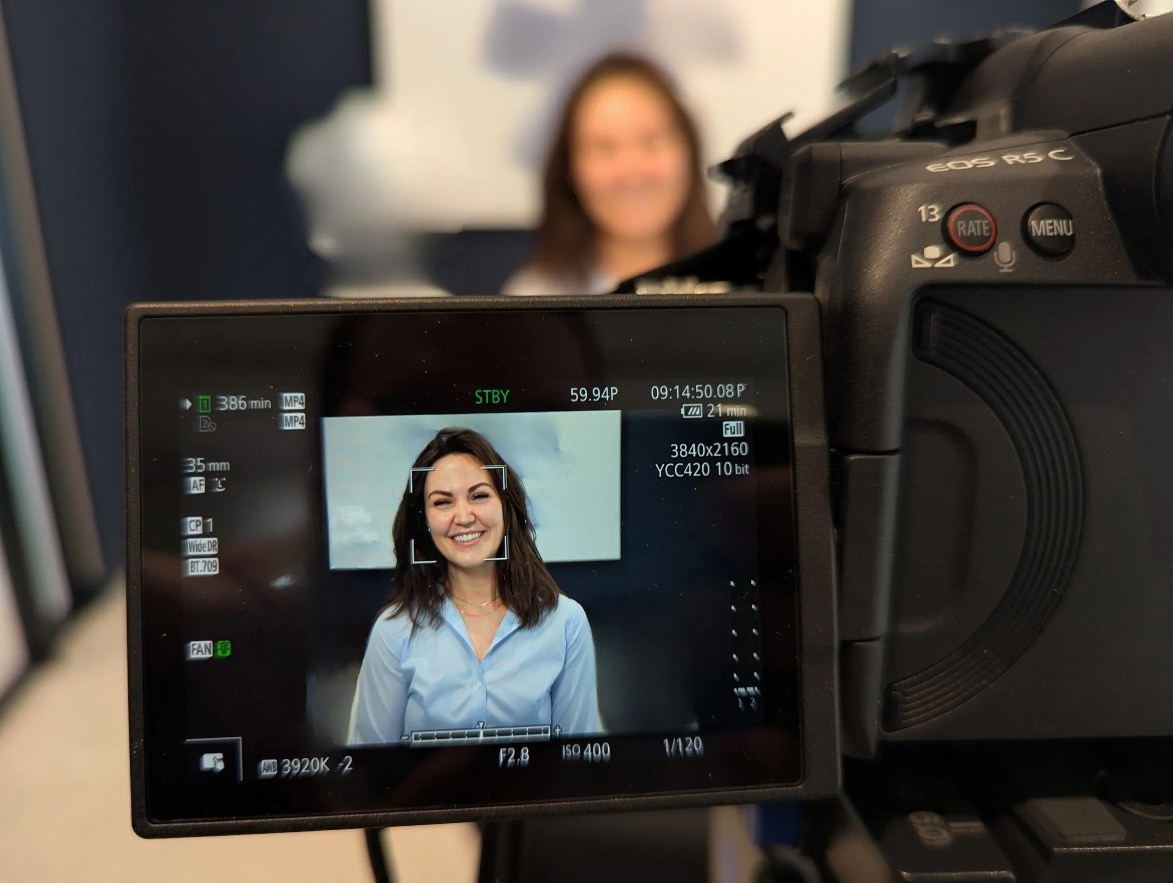 Eryn Peters being filmed for an interview, seen through the camera monitor