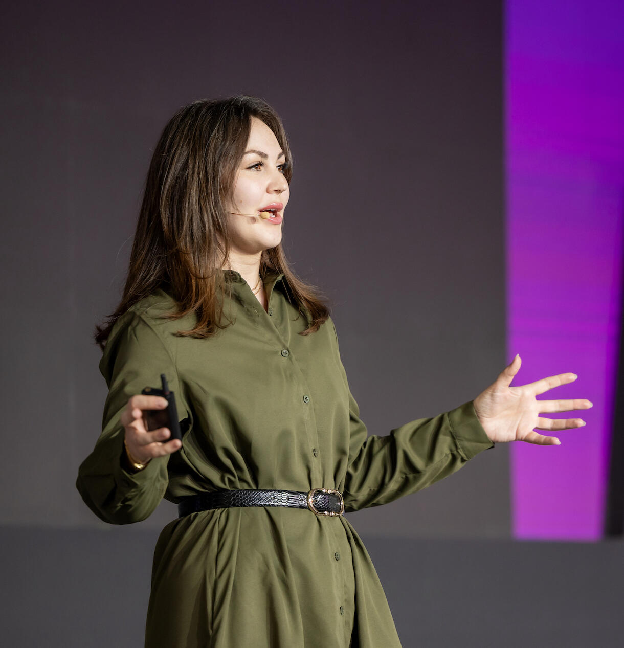 woman speaking at a major conference on a keynote stage